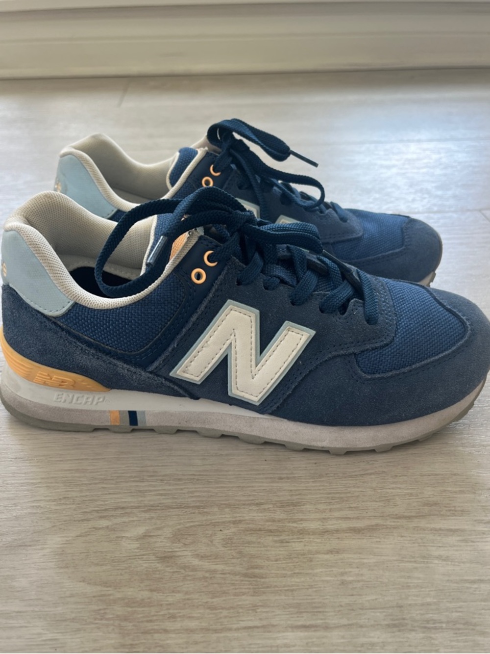 New Balance 574 Women’s Navy and Light Blue White Orange Accent Sneakers